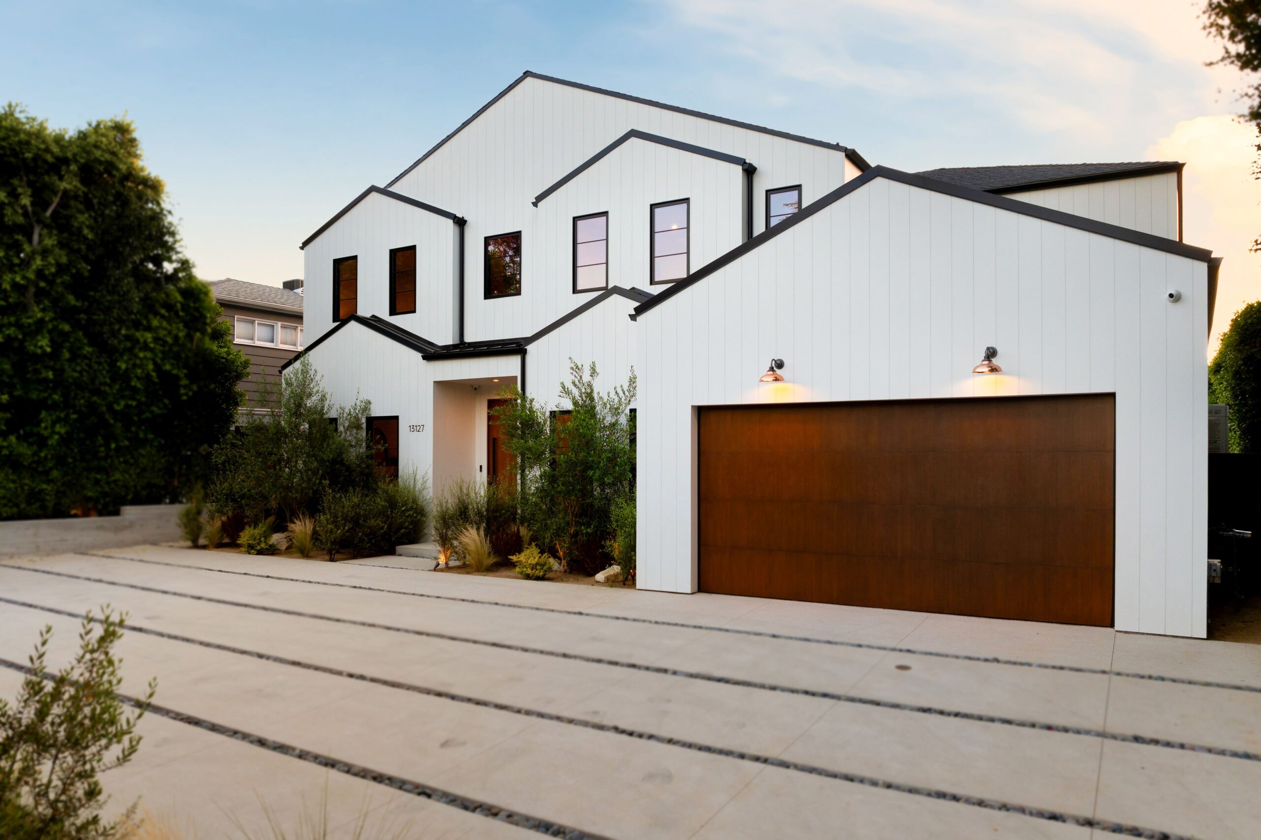 Home exterior after residential pressure washing, showing bright siding and clean driveway.